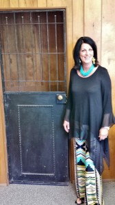 Judge Halfmann checks in on the courthouse renovation. Here she is pictured next to the door of an old, original holding cell located behind the district courtroom. Photo courtesy of Lonnie Hunt. 